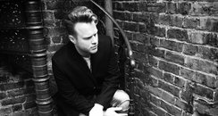 Olly Murs sitting on stairs