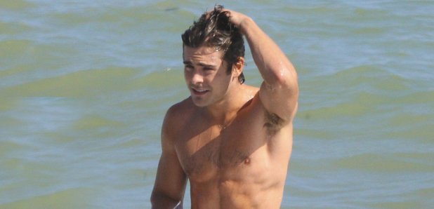 Zac Efron topless on the beach on holiday 