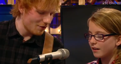 Ed Sheeran singing with young fan video still 