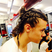 Image 8: Harry Styles with braids in his hair 
