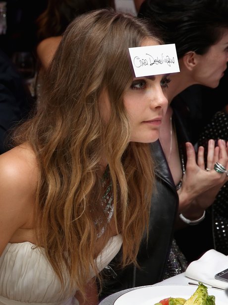 Cara Delevingne with a name tag on her forehead