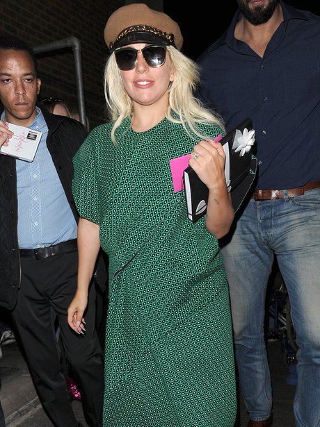 lady gaga covered up in a green outfit