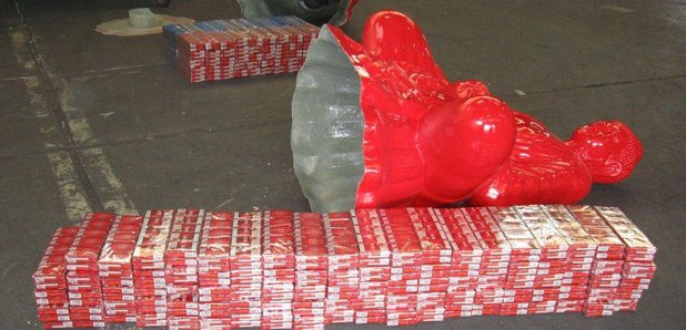 cigarettes in buddha statue