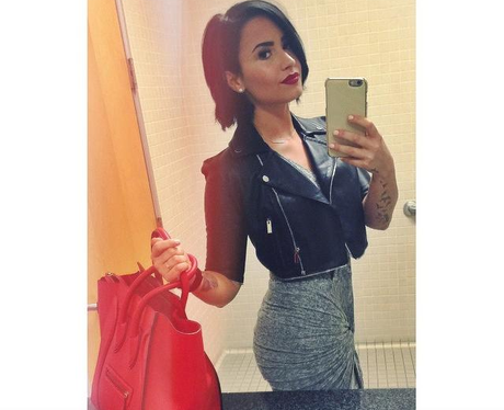 Demi Lovato wearing a leather jacket 