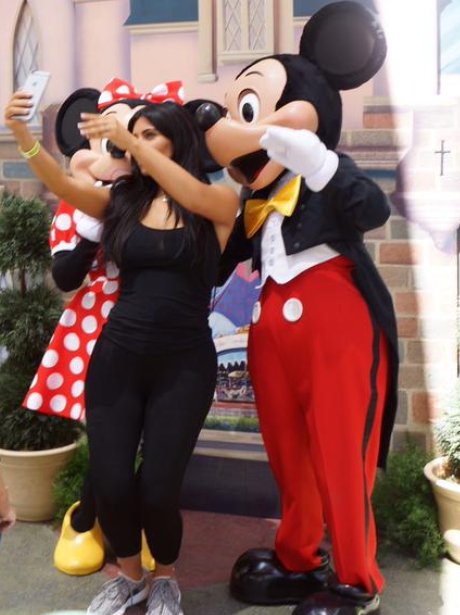 Kim Kardashian taking a selfie with Micky Mouse