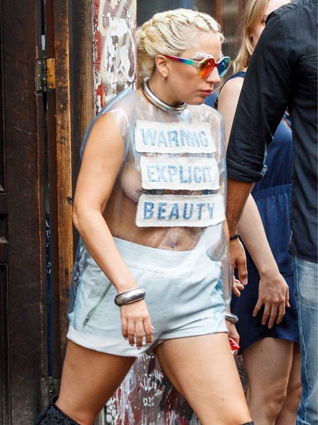 Lady Gaga topless wearing banners