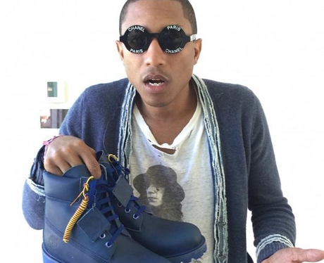 Pharrell Williams holding trainers