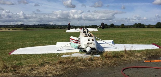 The small plane upside by the runway