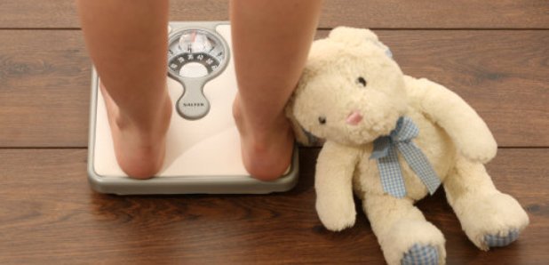 Obese child on scales 