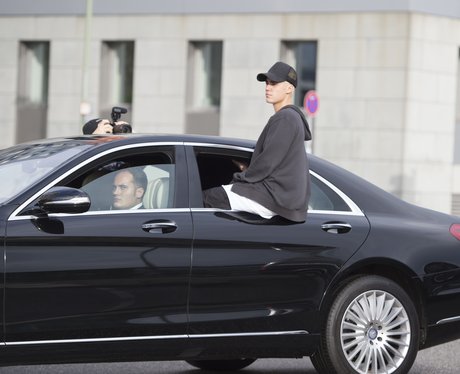 Justin Bieber sitting on car