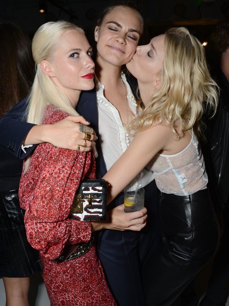 Sisterly love! Cara poses with sister Poppy Delevingne backstage at