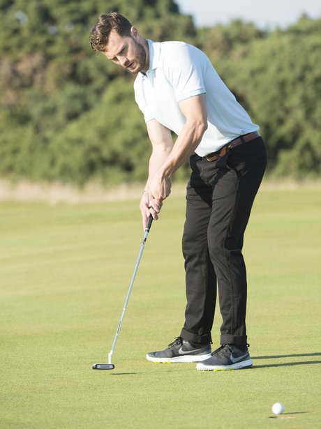 Jamie Dornan playing golf