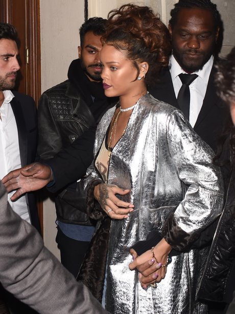 Rihanna wearing a silver jacket