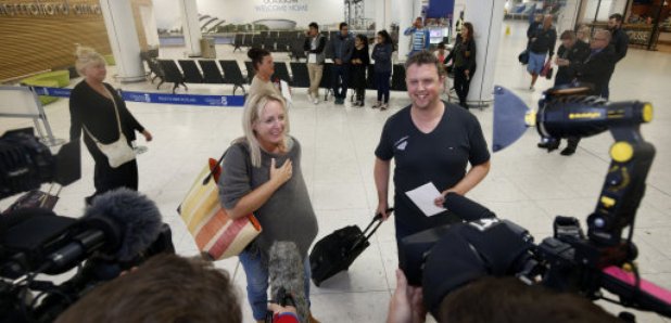A couple arrive at Glasgow Airport from Sharm