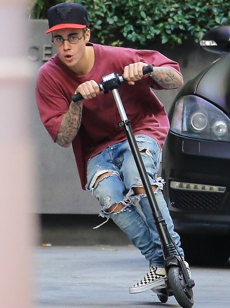 Not only is Biebs rocking the HELL out of these specs... he's whizzing ...