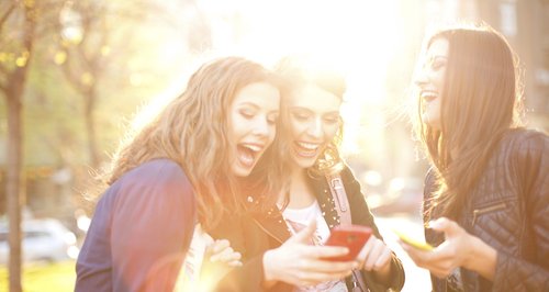 friends laughing on their phone