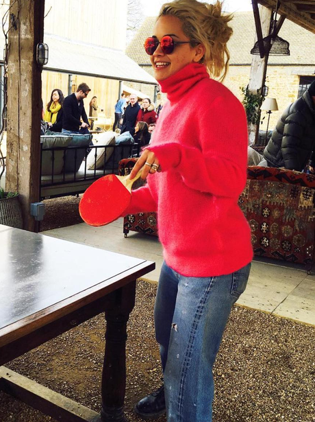 Rita Ora plays ping pong in red jumper