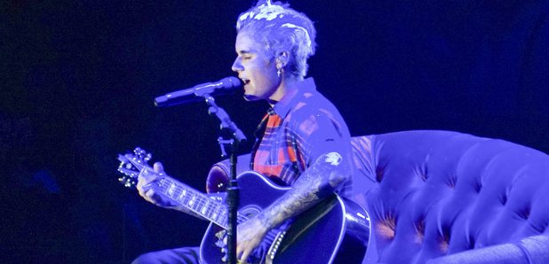 Justin Bieber performs with acoustic guitar 