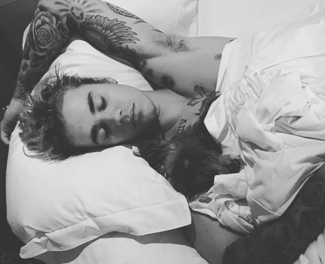 Justin Bieber cosies up in bed with his dog