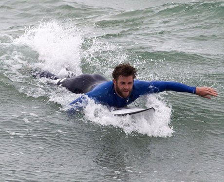 Liam Hemsworth goes surfing