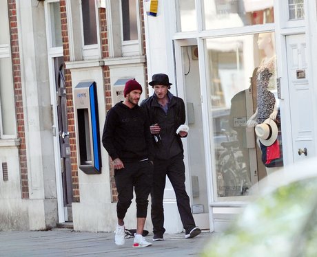 David Beckham gives a homeless man a beer and a bu
