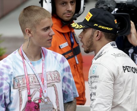 Justin Bieber celebrates with Lewis Hamilton
