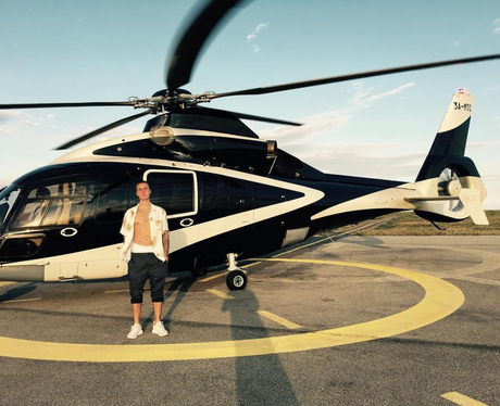 Justin Bieber infront of a helicopter