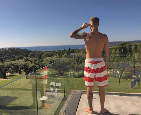 Justin Bieber poses in playboy shorts as he soaks up the view... and ...