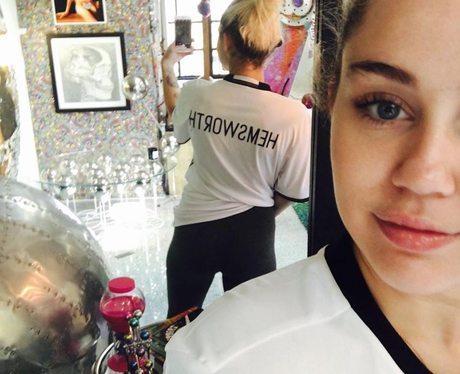 Miley Cyrus poses in Hemsworth shirt