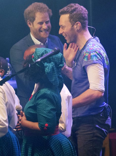 Prince Harry on stage with Chris Martin Coldplay