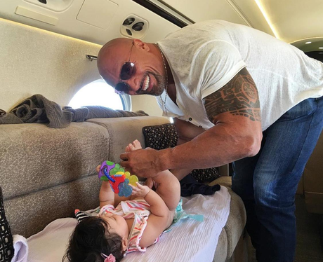 The Rock changes a nappy on board private jet