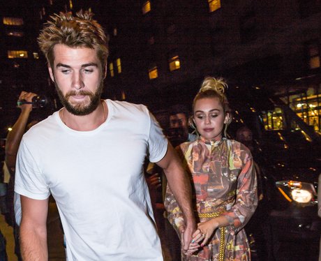 Miley Cyrus holding hands with Liam Hemsworth