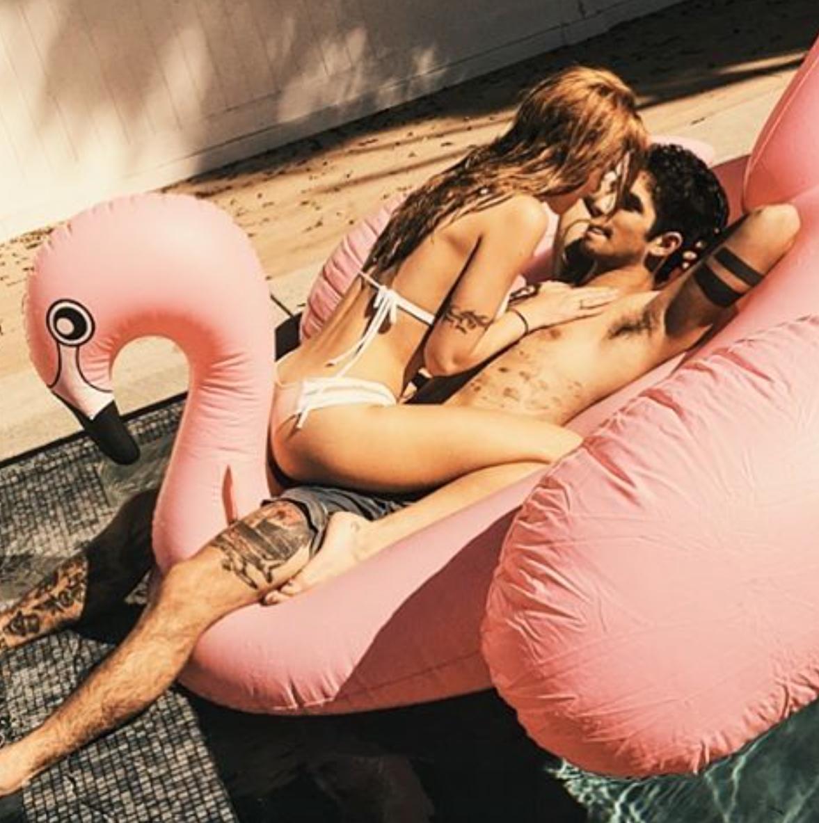 Bella Thorne and Tyler Posey pose in the pool