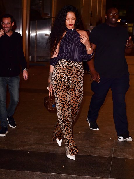 Rihanna wears leopard print trousers out and about