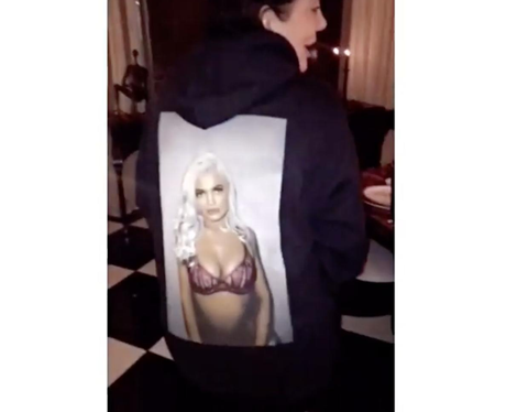 Kris Jenner wears a hoodie with a half naked Kylie