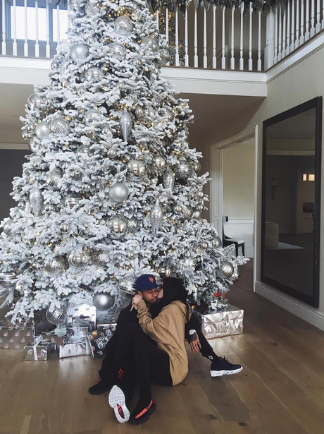 Kylie Jenner and Tyga cuddle up under the Christma
