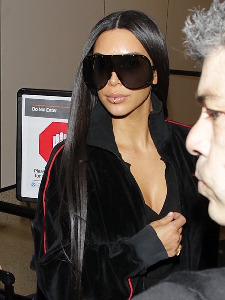 Kim Kardashian wears a lip ring as she lands into