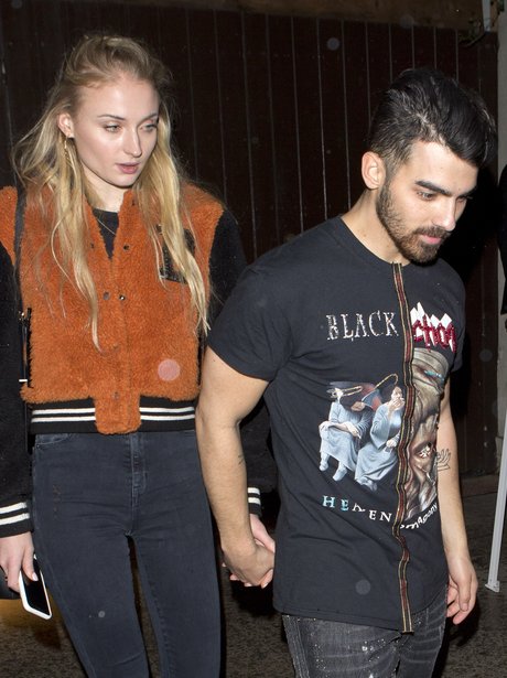 Sophie Turner and Joe Jonas hold hands as they lea