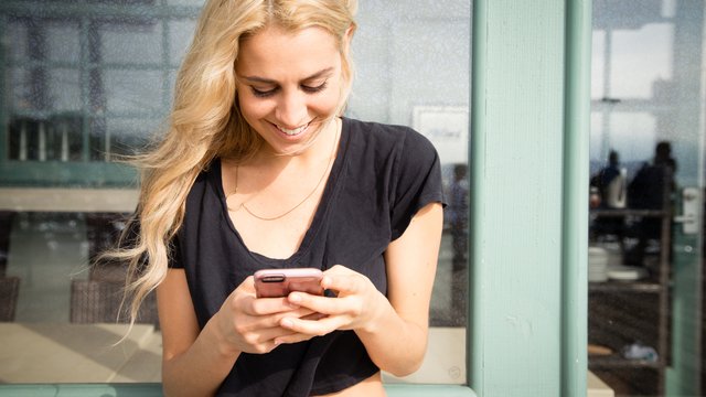 Young Woman Looking At Mobile Phone