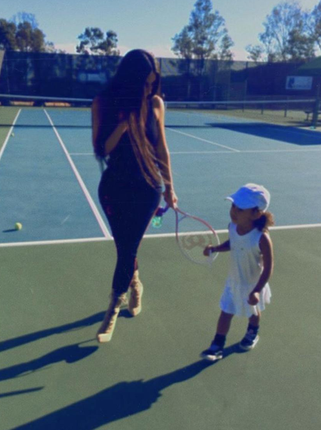 Kim Kardashian plays tennis in heels with North