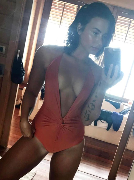 Demi Lovato shows off bikini body and impressive t