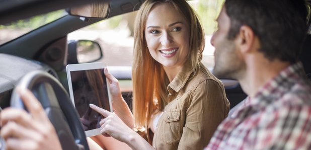 Couple In Car With iPad