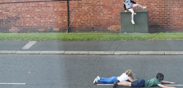Children play chicken with traffic on the streets