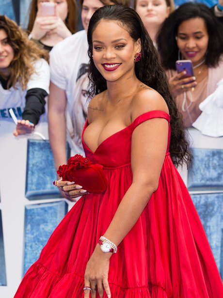 Rihanna opts for a busty dress as she attends the