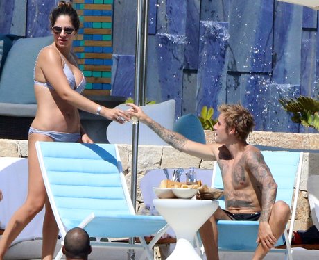 Justin Bieber raises a glass with mysterious lady