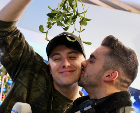 Roman and Rob kiss under mistletoe 
